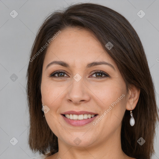 Joyful white adult female with long  brown hair and brown eyes