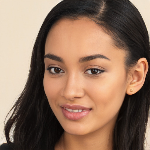 Joyful latino young-adult female with long  brown hair and brown eyes