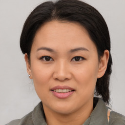 Joyful asian young-adult female with medium  brown hair and brown eyes