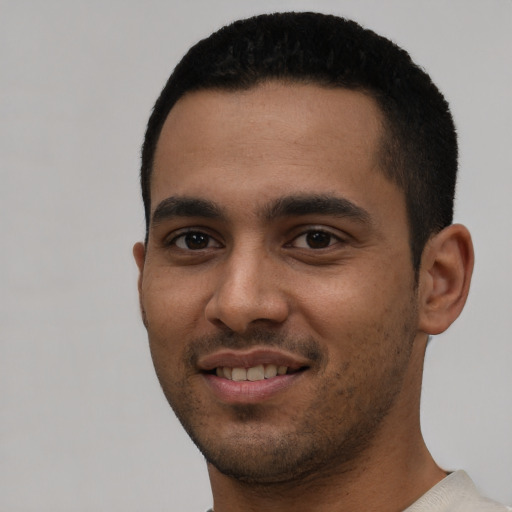 Joyful latino young-adult male with short  black hair and brown eyes