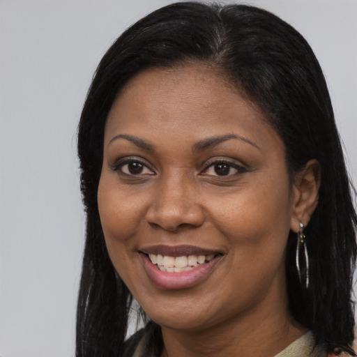 Joyful black young-adult female with long  brown hair and brown eyes