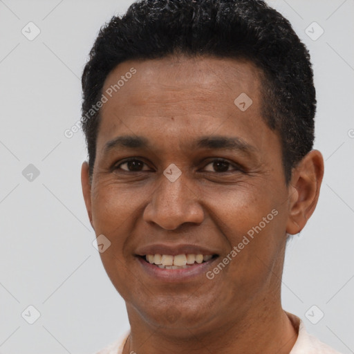 Joyful latino adult male with short  black hair and brown eyes