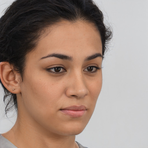 Neutral latino young-adult female with medium  brown hair and brown eyes
