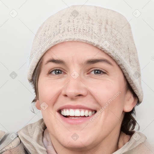 Joyful white adult female with short  brown hair and blue eyes