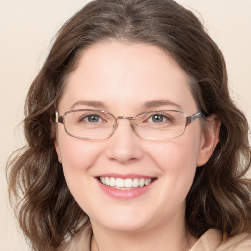 Joyful white adult female with long  brown hair and blue eyes