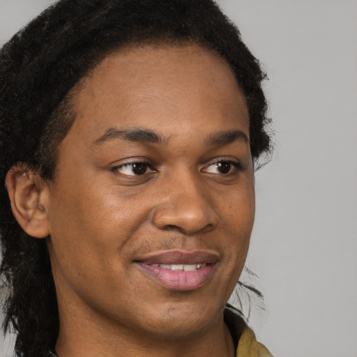 Joyful black young-adult male with short  brown hair and brown eyes