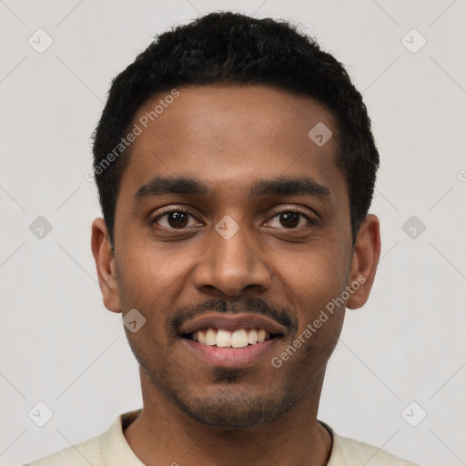 Joyful black young-adult male with short  black hair and brown eyes
