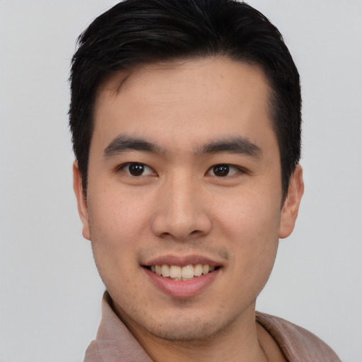 Joyful asian young-adult male with short  brown hair and brown eyes