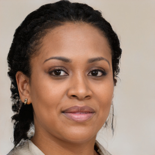 Joyful black young-adult female with medium  black hair and brown eyes