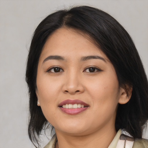 Joyful asian young-adult female with medium  brown hair and brown eyes