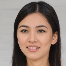 Joyful asian young-adult female with long  brown hair and brown eyes