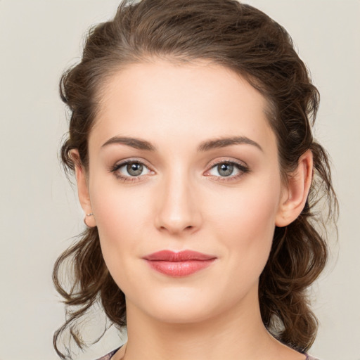 Joyful white young-adult female with medium  brown hair and green eyes