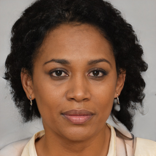 Joyful latino adult female with short  brown hair and brown eyes