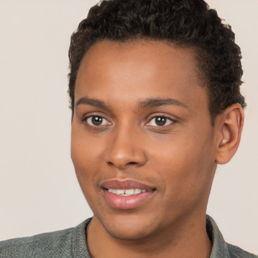 Joyful black young-adult male with short  brown hair and brown eyes