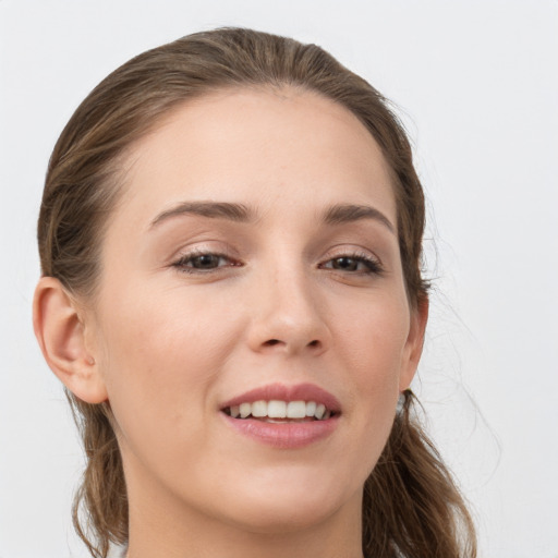 Joyful white young-adult female with long  brown hair and grey eyes