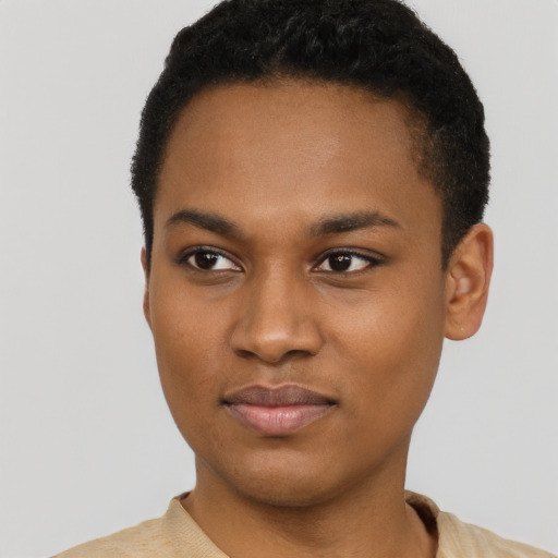 Joyful black young-adult male with short  black hair and brown eyes
