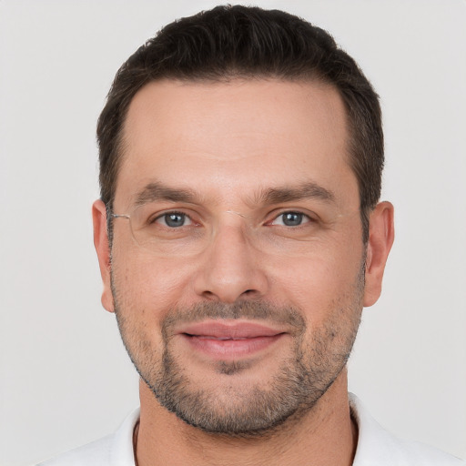 Joyful white young-adult male with short  brown hair and brown eyes