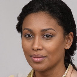 Joyful black young-adult female with long  brown hair and brown eyes