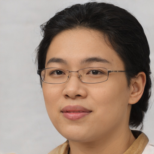Joyful asian young-adult female with short  brown hair and brown eyes
