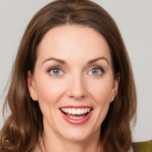 Joyful white young-adult female with medium  brown hair and blue eyes