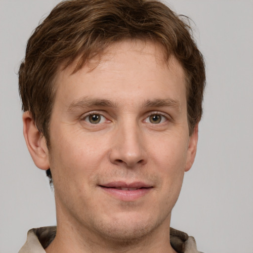 Joyful white adult male with short  brown hair and grey eyes