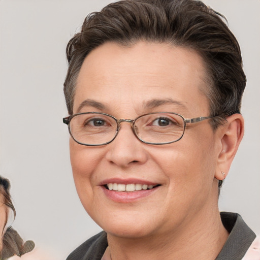 Joyful white adult female with short  brown hair and brown eyes