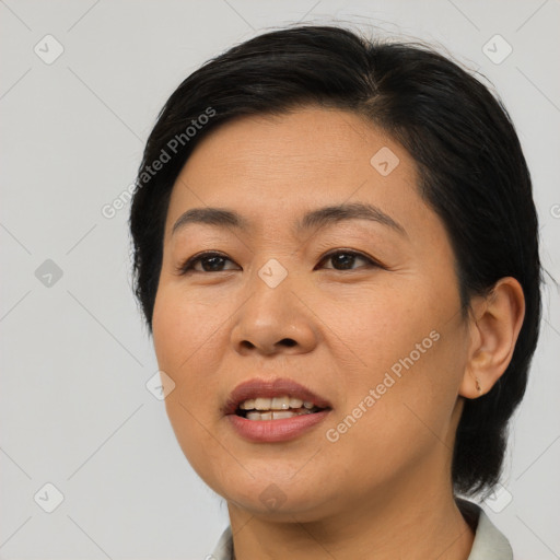 Joyful asian young-adult female with medium  black hair and brown eyes