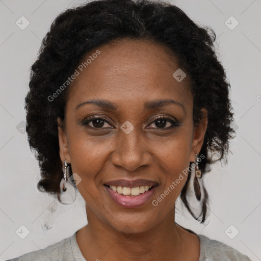 Joyful black adult female with short  brown hair and brown eyes