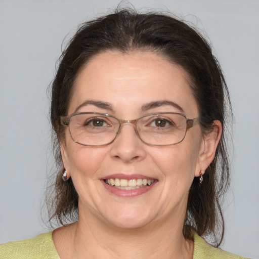 Joyful white adult female with medium  brown hair and brown eyes