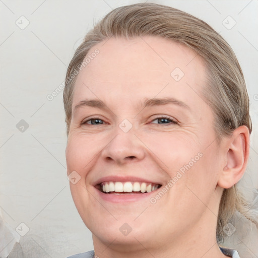 Joyful white young-adult female with medium  brown hair and blue eyes