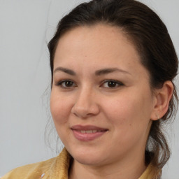 Joyful white young-adult female with medium  brown hair and brown eyes