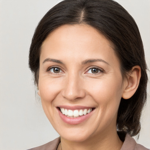 Joyful white young-adult female with medium  brown hair and brown eyes