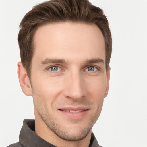 Joyful white young-adult male with short  brown hair and grey eyes