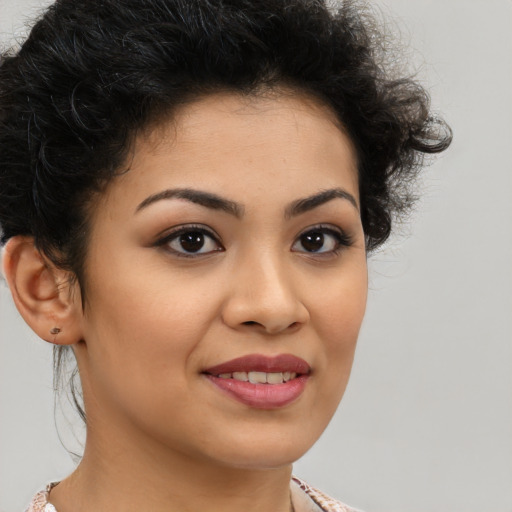 Joyful latino young-adult female with short  brown hair and brown eyes
