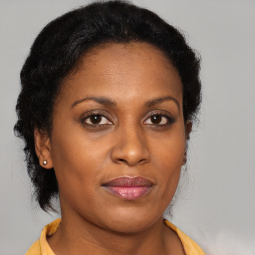 Joyful black young-adult female with medium  brown hair and brown eyes
