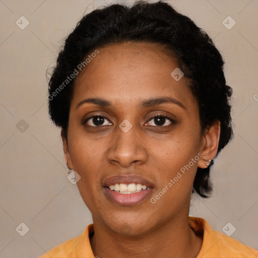 Joyful black young-adult female with short  black hair and brown eyes