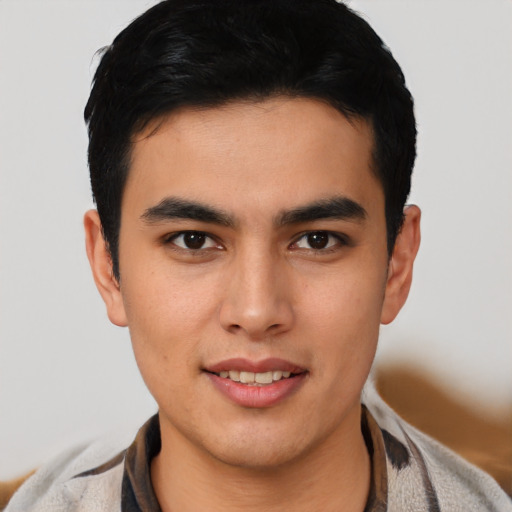 Joyful latino young-adult male with short  black hair and brown eyes