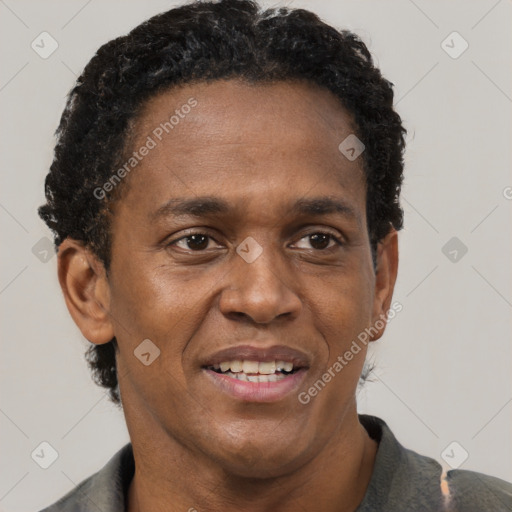 Joyful black adult male with short  black hair and brown eyes