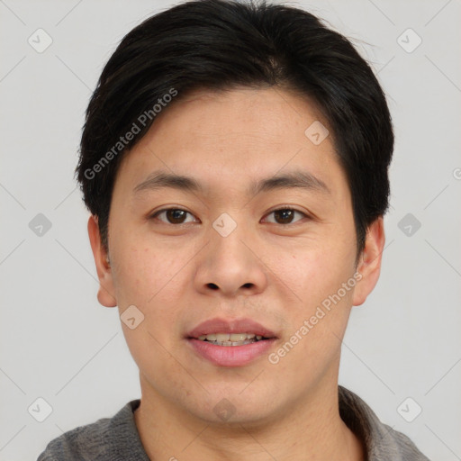 Joyful asian young-adult male with short  brown hair and brown eyes