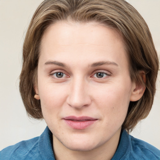 Joyful white young-adult female with medium  brown hair and blue eyes