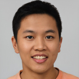 Joyful asian young-adult male with short  black hair and brown eyes