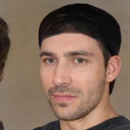 Joyful white young-adult male with short  black hair and brown eyes