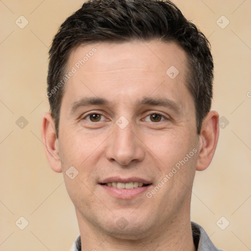 Joyful white adult male with short  brown hair and brown eyes