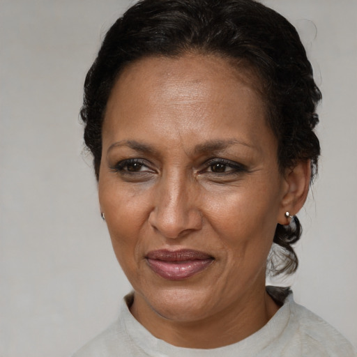 Joyful black adult female with short  brown hair and brown eyes