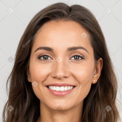 Joyful white young-adult female with long  brown hair and brown eyes