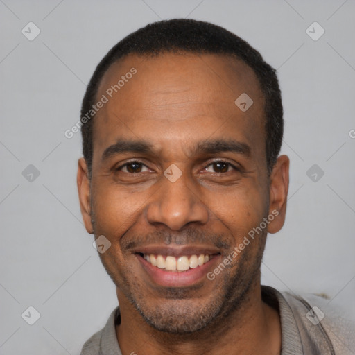 Joyful latino adult male with short  black hair and brown eyes