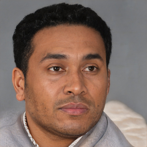 Neutral latino young-adult male with short  brown hair and brown eyes