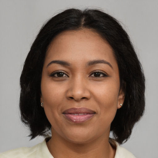 Joyful latino adult female with medium  brown hair and brown eyes