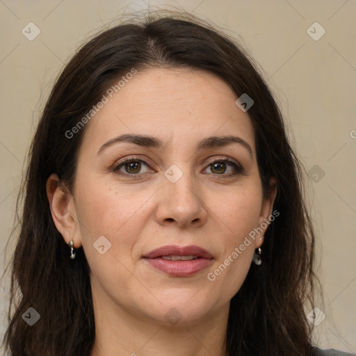 Joyful white adult female with long  brown hair and brown eyes