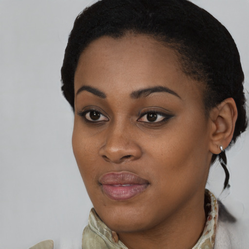 Joyful black young-adult female with medium  brown hair and brown eyes